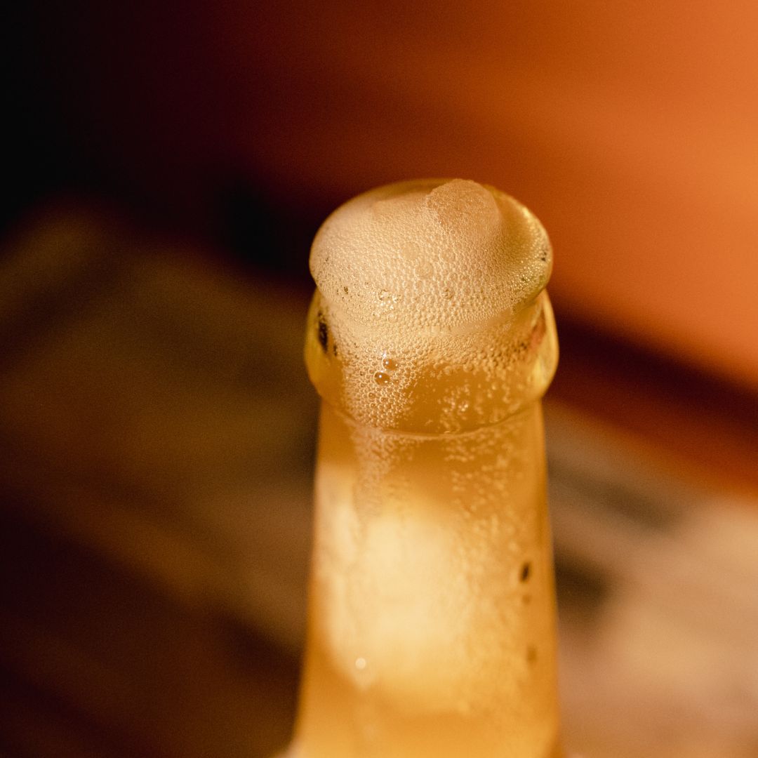 Close-up of a bottle cap with condensation on a blurred background