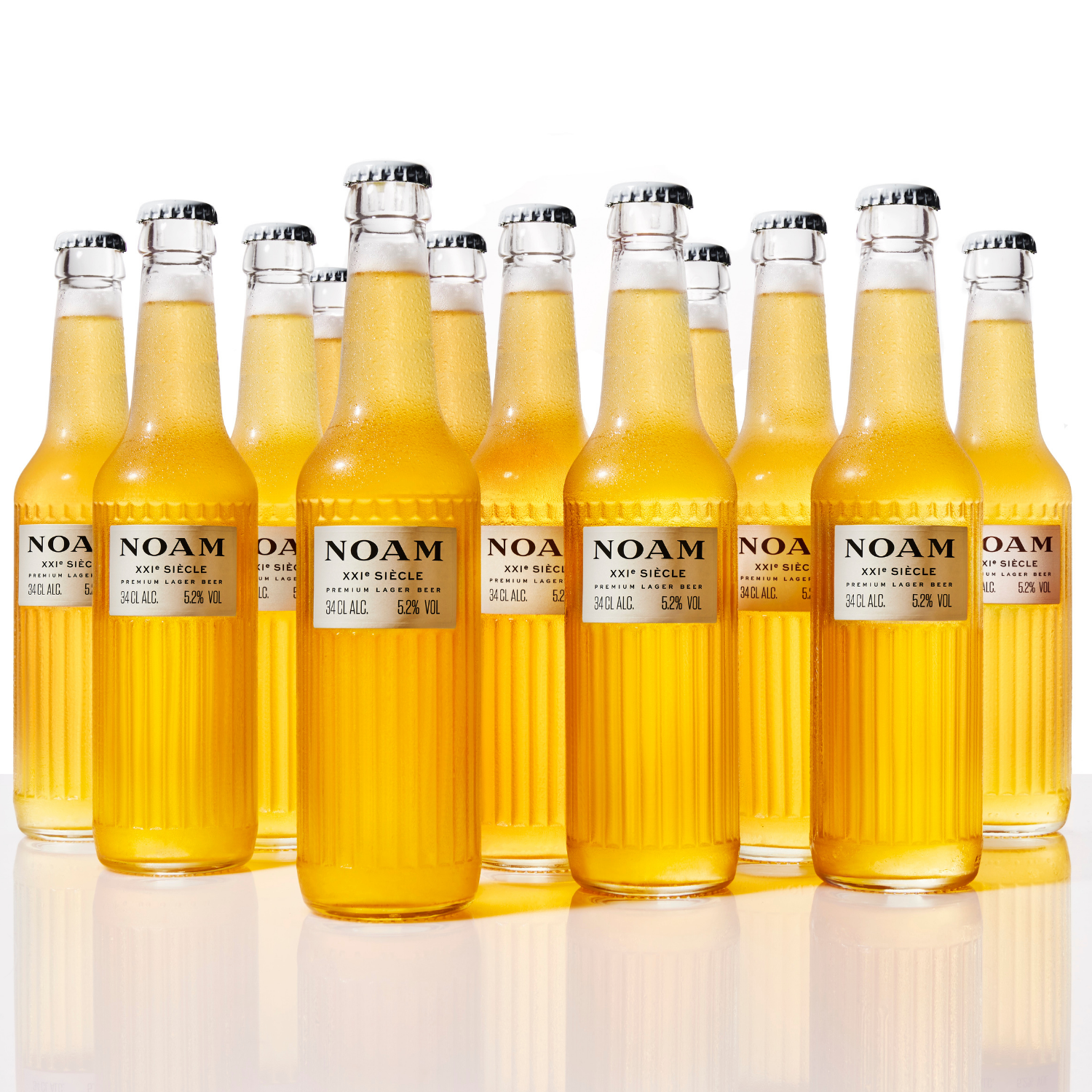 Multiple bottles of NOAM craft beer arranged in a row on a reflective surface with a white background.