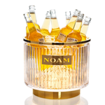 Beverage cooler with bottles labeled 'NOAM' on a white background